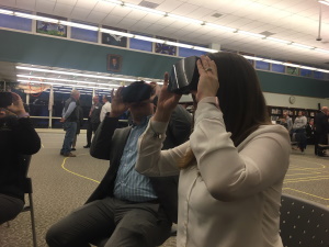 Attorney Landon Hodges (left) and long-term care planner Kristin Daugherty, experience some virtual reality glasses at the PM Exchange held at Hughesville High School in February.